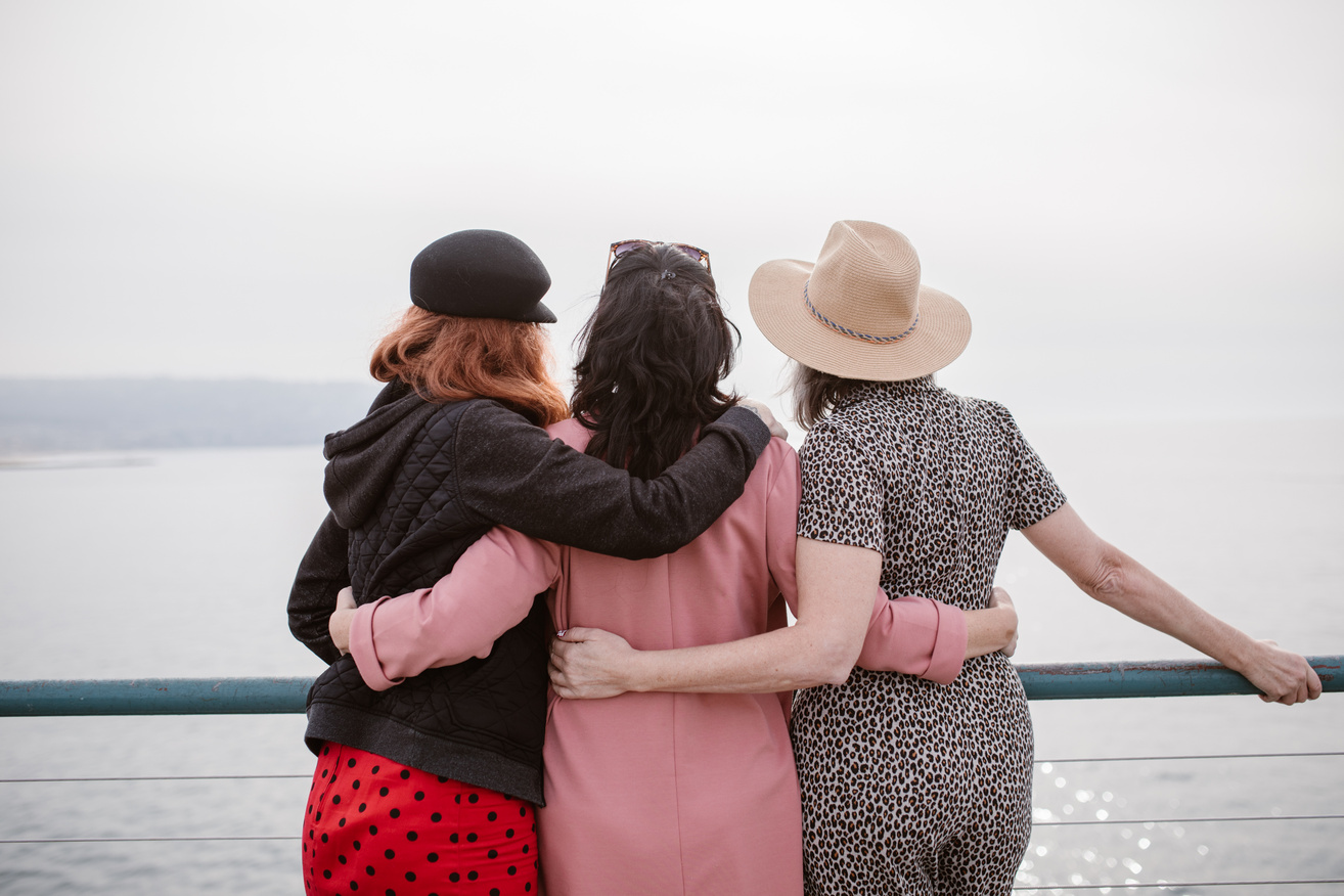 People Hugging while Looking at the Beach